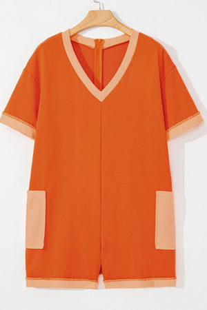 Orange colorblock V-neck romper with patch pockets and short sleeves.