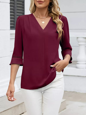 Wine red V-neck blouse with 3/4 sleeves featuring lace trim detail.