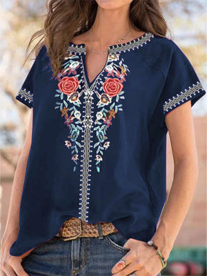 Navy blue blouse with floral embroidery and notched neckline.