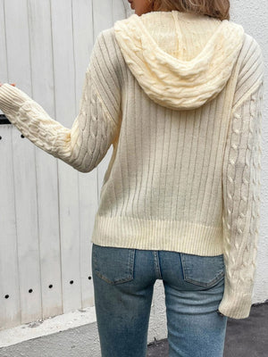 Pastel yellow cable knit zip-up hooded jacket with detailed sleeves and ribbed hem.