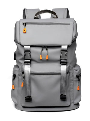 Gray tech-utility backpack with contrast orange zipper pulls and silver buckles.