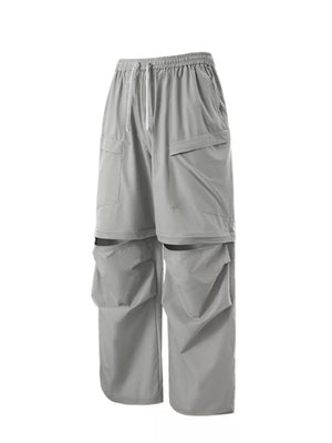 Gray cargo pants with adjustable drawstring waist and zip-off legs.