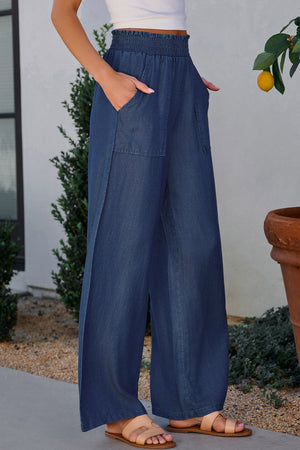 Shirred waist denim palazzo trousers in peacock blue, made of 100% lyocell, with wide legs and patch pockets.