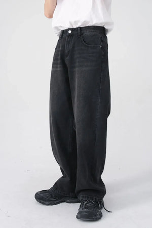 Black denim jeans with a relaxed fit and visible pockets, styled casually.