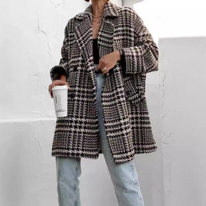 Oversized houndstooth cocoon coat in black and white with a notched lapel and relaxed fit.