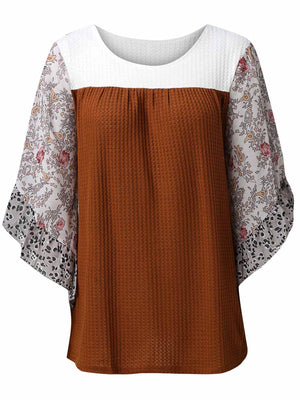 Textured panel blouse with floral flutter sleeves and round neckline.