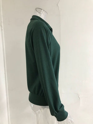 Green ribbed knit trench coat with a collar and long sleeves.