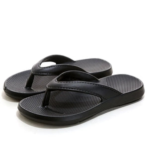 Black textured rubber thong sandals with a waffle-patterned footbed.
