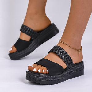Chic black two-strap platform sandals with braided detail and chunky sole.