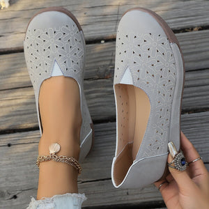 Grey floral cutout slip-on loafers with breathable design and comfortable fit.