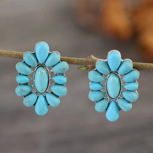Turquoise petal stud earrings in silver with teardrop accents.