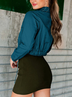 Peacock blue cropped utility jacket with drawstring hem and buttoned cuffs.
