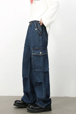 Denim palazzo cargo pants in dark wash with multiple pockets and a baggy fit.