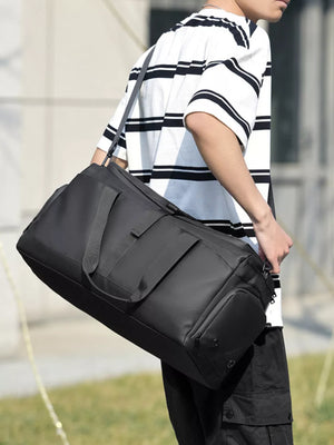 Black Oxford cloth travel bag with multiple pockets and a detachable strap.