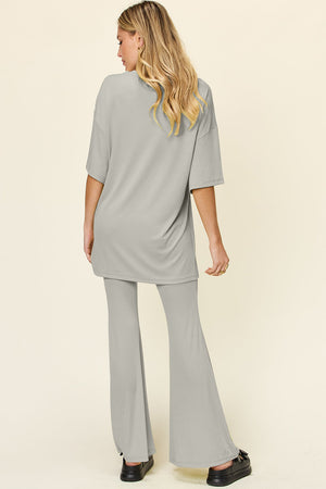 Light gray oversized tee and flare leg pants set from the back.