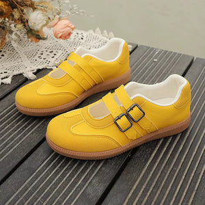 Yellow Mary Jane inspired sneakers with double buckle straps and white lining.