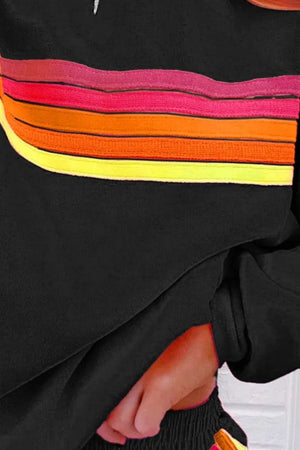Black loungewear set with retro stripe detail in pink, orange, and yellow.