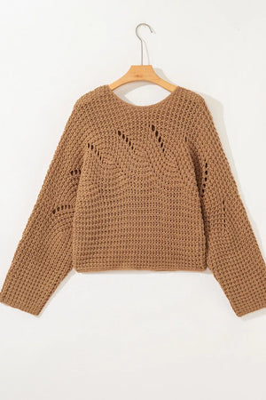 Brown chunky knit sweater with wide sleeves and open knit details