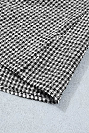 Black and white gingham ruffled sleeve shirt made of polyester.