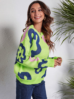 Neon floral knit crewneck sweater in light green with blue and pink abstract floral pattern.