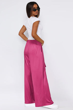 Hot Pink wide-leg flow pants with self-tie belt and pockets.