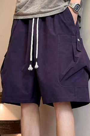 Relaxed fit cargo shorts in purple with drawstring waist and button flap pockets.