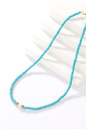 Turquoise bead necklace with pearl and gold accent detail