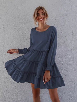 Navy blue ruffled mini dress with long sleeves and tiered skirt