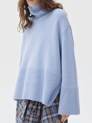 Light blue ribbed turtleneck sweater with flared sleeves and ribbed hem detail.