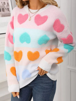 Fuzzy knit sweater with pastel heart pattern and color block stripes.