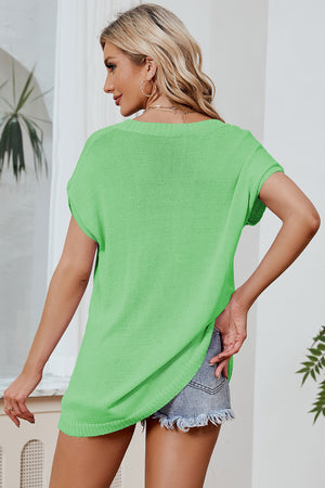 Neon green knit tee with dolman sleeves and a relaxed fit, styled with denim shorts.