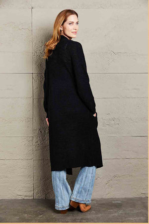 Black textured knit maxi cardigan with pockets, acrylic, long sleeve, open front.