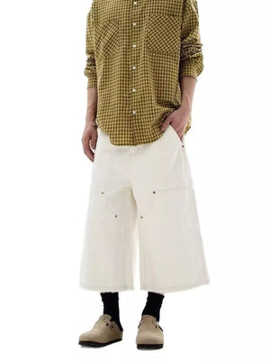 Men's white cotton wide-leg cropped cargo pants with frayed hem.