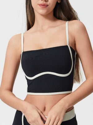 Black contour-trimmed crop top with cream piping and thin straps.