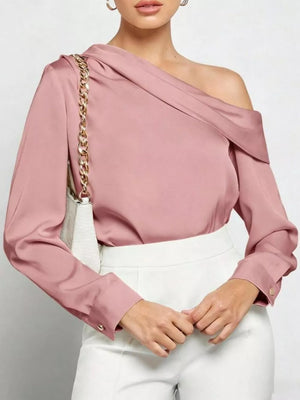 Elegant one-shoulder satin shirt in dusty rose with draped neckline and button cuffs.