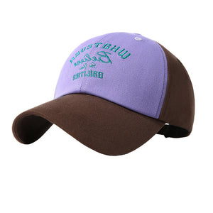 Embroidered two-tone baseball cap in purple and brown with green text detail.
