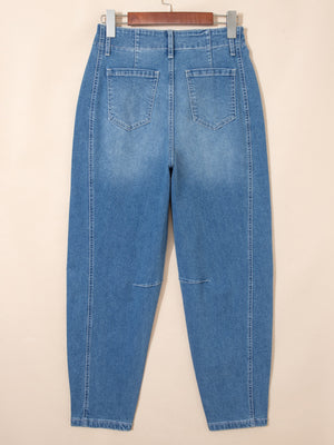 High-waisted blue denim barrel jeans with cuffed ankles and subtle knee details.