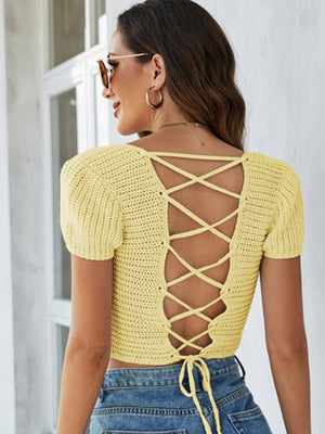 Yellow crochet crop top with short sleeves and lace-up back detail.