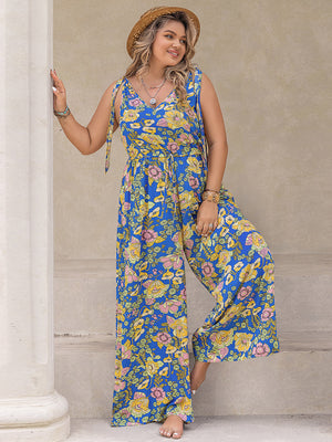 Blue floral tie-shoulder wide-leg jumpsuit with v-neck and drawstring waist.