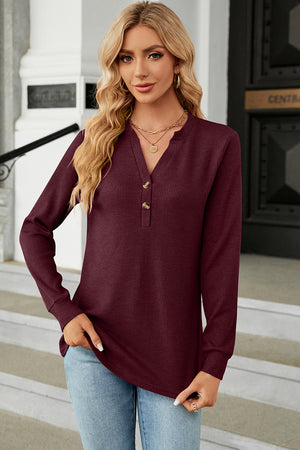 Burgundy waffle knit henley shirt with button placket and long sleeves.