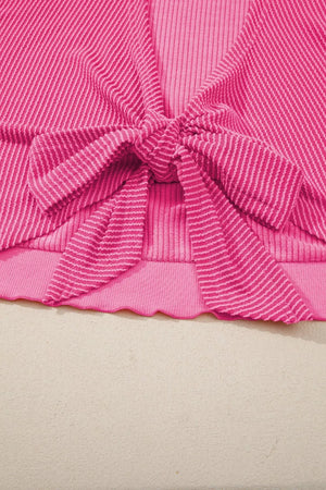Pink ribbed maternity t-shirt with a tie-front bow detail