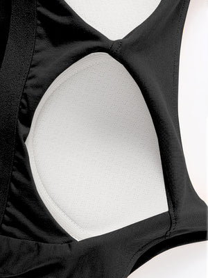 Black built-in bustier crop camisole with white textured lining and elastic trim.