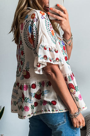 Embroidered medallion peplum blouse with ruffles in floral.