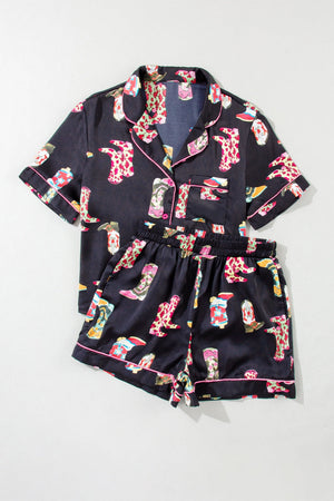 Black silk pajama set with colorful boot print and pink piping.