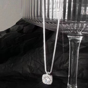 Sterling silver square pendant necklace with dazzling stones on a delicate chain.