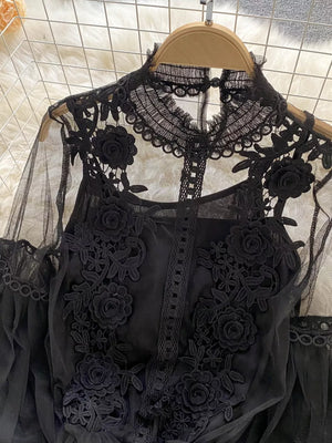 Black lace blouse with floral embroidery and sheer sleeves, paired with a cami.