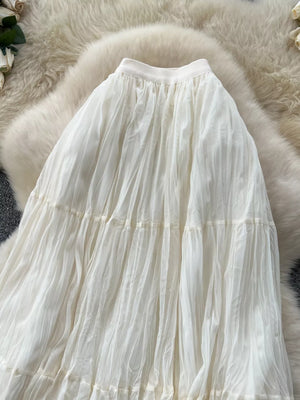 Elegant tiered tulle skirt with lining in apricot, featuring a flowy, pleated design.