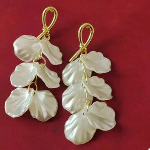 Elegant beige shell drop earrings with gold hardware.