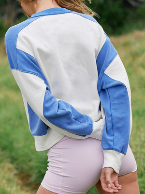 Blue and white contrast sleeve sweater with ribbed collar and cuffs.
