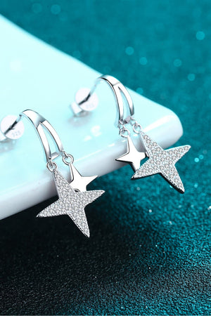 Silver celestial starburst drop earrings with pave crystal accents.